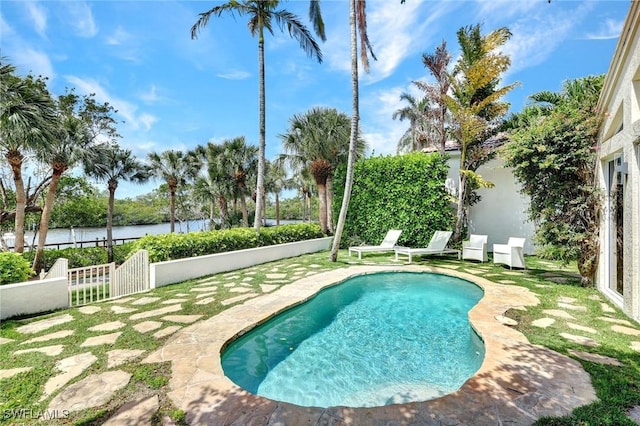 27571 Riverbank Dr, Bonita Springs, FL 34134 - view of swimming pool featuring a water view, fence, a fenced in pool, and a patio