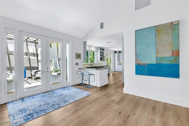 27571 Riverbank Dr, Bonita Springs, FL 34134 - entryway featuring french doors, wood finished floors, vaulted ceiling, and visible vents