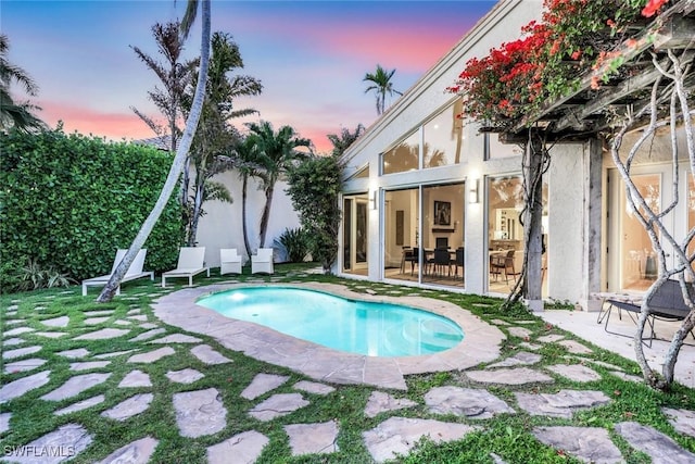 27571 Riverbank Dr, Bonita Springs, FL 34134 - pool at dusk featuring a fenced in pool and a patio area