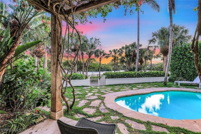 27571 Riverbank Dr, Bonita Springs, FL 34134 - pool at dusk with a fenced in pool