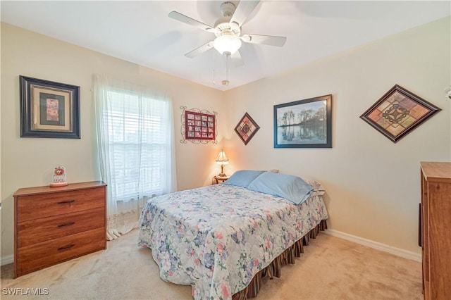 carpeted bedroom featuring baseboards and ceiling fan