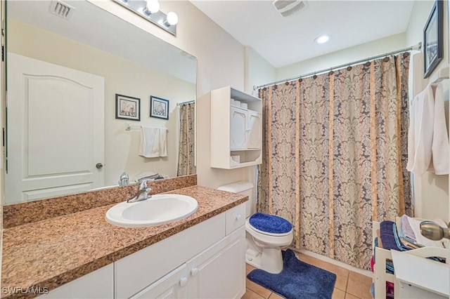 bathroom with tile patterned flooring, vanity, toilet, and visible vents