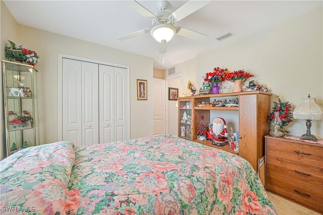 bedroom featuring carpet flooring, a closet, ceiling fan, and visible vents