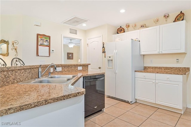 kitchen featuring visible vents, dishwasher, white fridge with ice dispenser, white cabinetry, and a sink