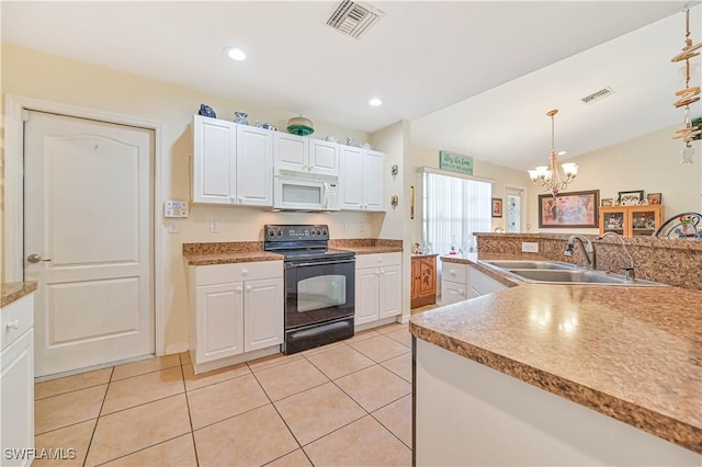 kitchen with visible vents, a chandelier, a sink, white microwave, and electric range