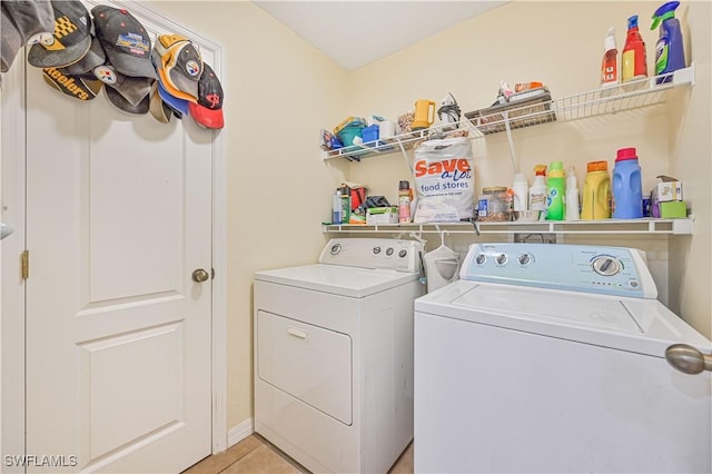 washroom featuring washer and dryer, laundry area, and light tile patterned floors