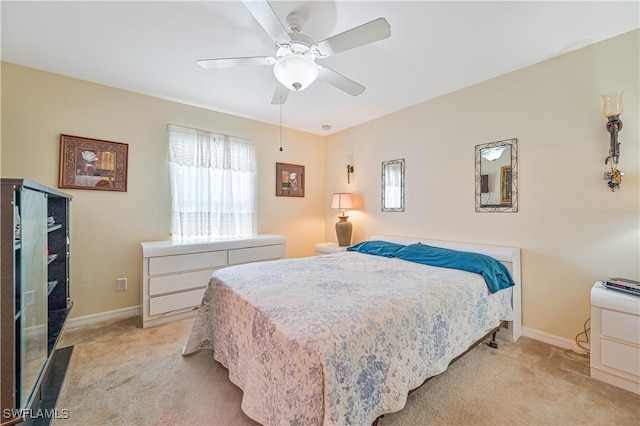 bedroom with light carpet, baseboards, and ceiling fan