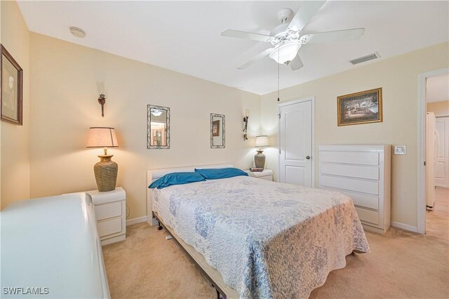 bedroom with light carpet, baseboards, visible vents, and ceiling fan