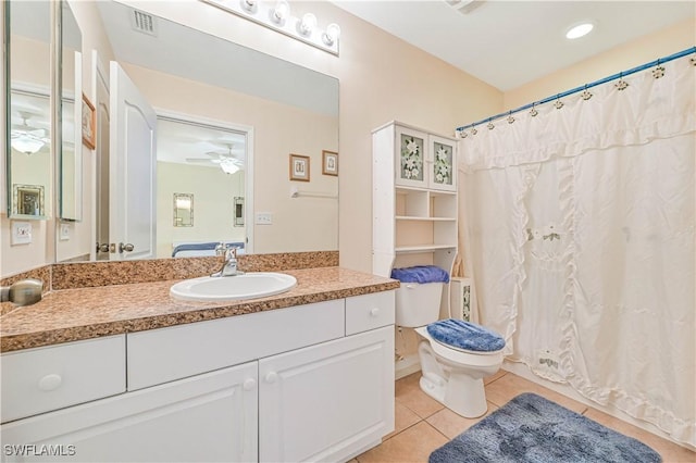 bathroom with tile patterned floors, toilet, vanity, visible vents, and ceiling fan