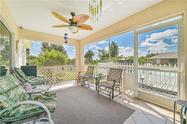 sunroom / solarium with a ceiling fan