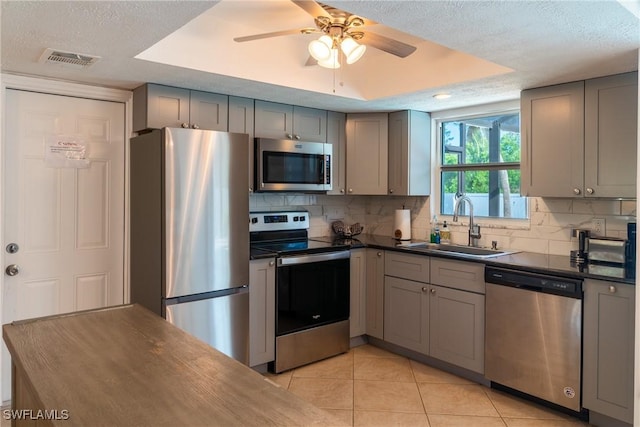 kitchen with stainless steel appliances and gray cabinetry