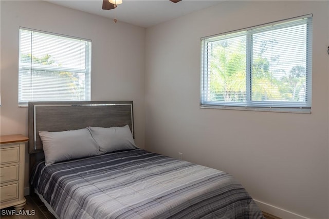 bedroom with multiple windows and a ceiling fan