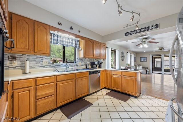 310 Trader Rd, Fort Denaud, FL 33935 - kitchen featuring light countertops, a peninsula, appliances with stainless steel finishes, a sink, and backsplash