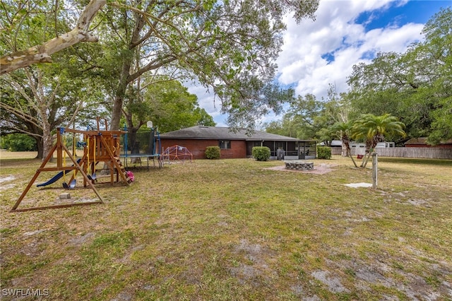 310 Trader Rd, Fort Denaud, FL 33935 - view of yard with a trampoline, a playground, and an outdoor fire pit