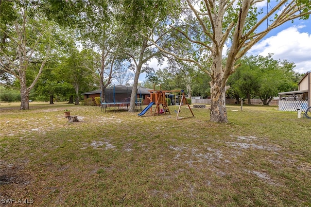 310 Trader Rd, Fort Denaud, FL 33935 - view of yard with a trampoline, a playground, and fence