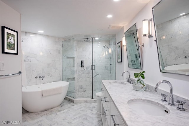 bathroom with a marble finish shower, marble finish floor, a sink, and a freestanding bath