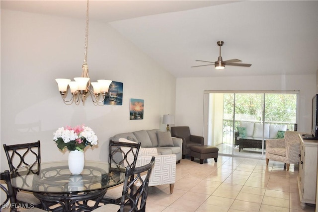 dining space with ceiling fan with notable chandelier, light tile patterned floors, and lofted ceiling