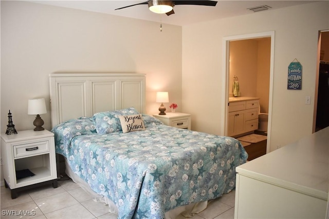 bedroom featuring light tile patterned floors, visible vents, connected bathroom, and ceiling fan