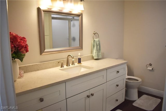 bathroom featuring vanity and toilet