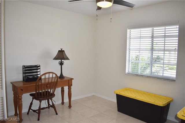 office space with baseboards and a ceiling fan
