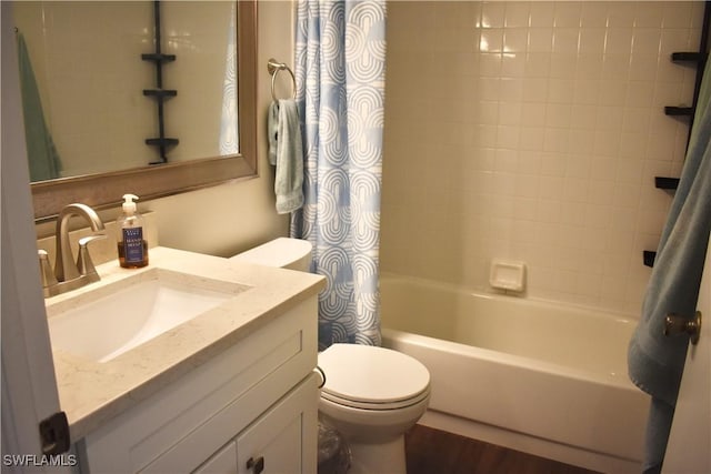 bathroom featuring shower / tub combo, toilet, vanity, and wood finished floors