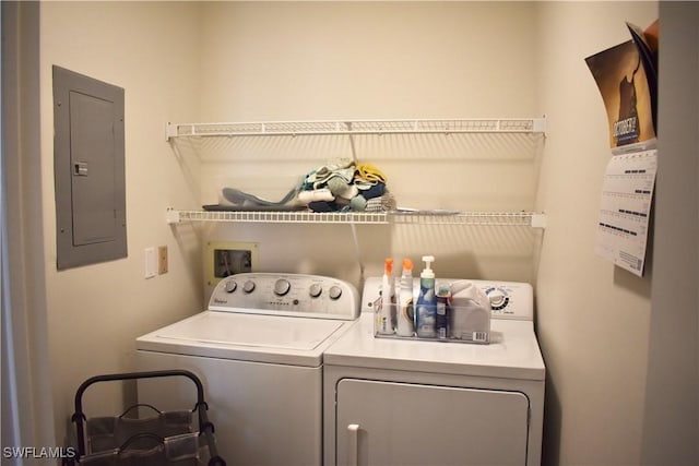 washroom with laundry area, separate washer and dryer, and electric panel