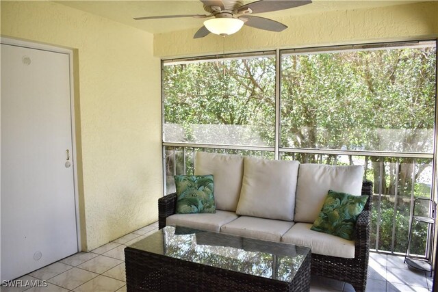 sunroom / solarium with plenty of natural light, outdoor lounge area, and a ceiling fan