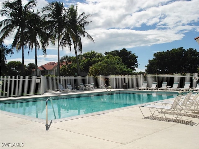pool featuring a patio area and fence