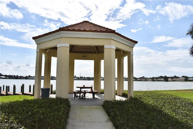 surrounding community featuring a water view, a gazebo, and a patio