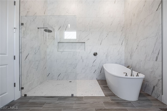 bathroom featuring a soaking tub and a walk in shower