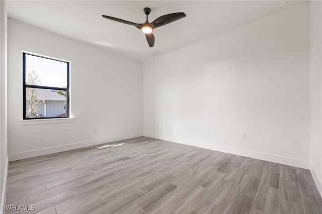 empty room with baseboards, light wood-style floors, and ceiling fan