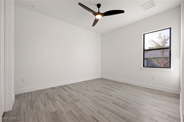 unfurnished room with baseboards, light wood-style flooring, visible vents, and ceiling fan