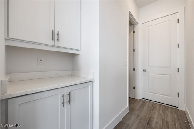 hall with wood finished floors and baseboards