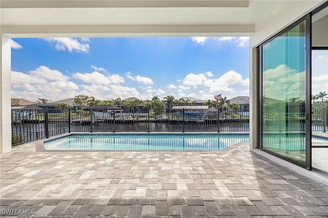 view of swimming pool featuring a fenced backyard, a water view, a patio area, and a fenced in pool