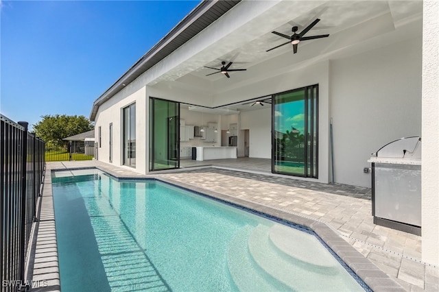 view of pool with fence, a patio area, a fenced in pool, and a ceiling fan