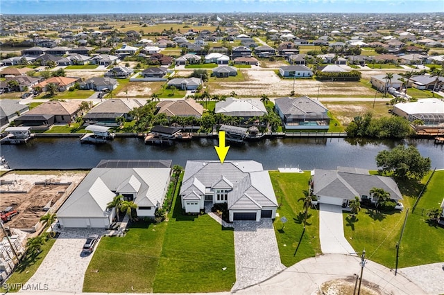 bird's eye view featuring a water view and a residential view