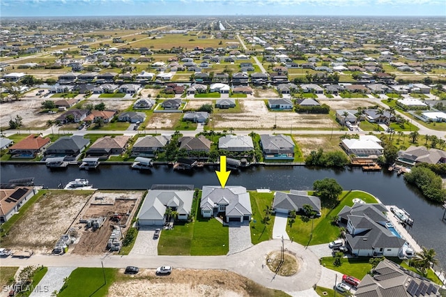 birds eye view of property with a residential view and a water view