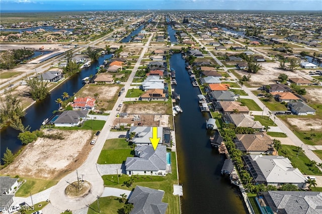 drone / aerial view featuring a residential view and a water view