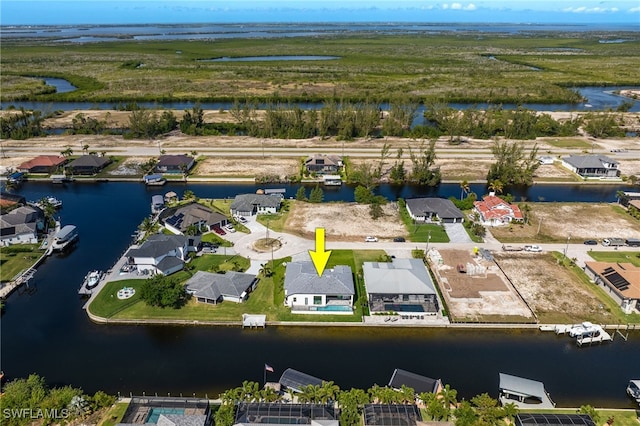 drone / aerial view with a residential view and a water view
