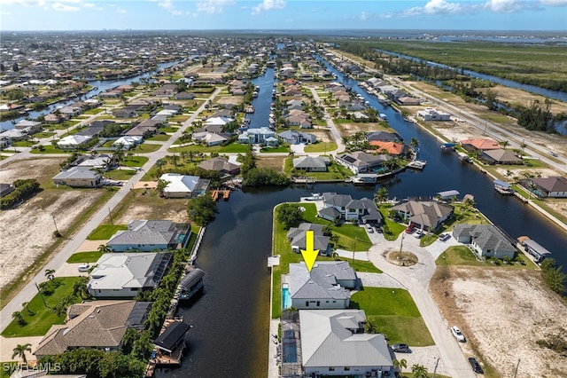 drone / aerial view featuring a residential view and a water view