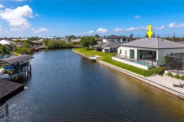 water view featuring a residential view, a dock, boat lift, and fence