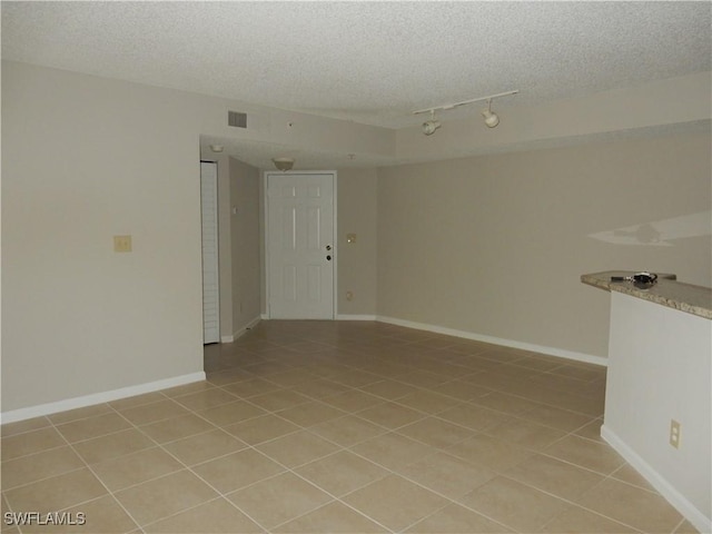 13621 Eagle Ridge Dr Unit 1518, Fort Myers, FL 33912 - empty room featuring light tile patterned floors, a textured ceiling, baseboards, and visible vents