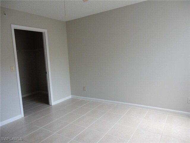 13621 Eagle Ridge Dr Unit 1518, Fort Myers, FL 33912 - empty room featuring light tile patterned flooring and baseboards