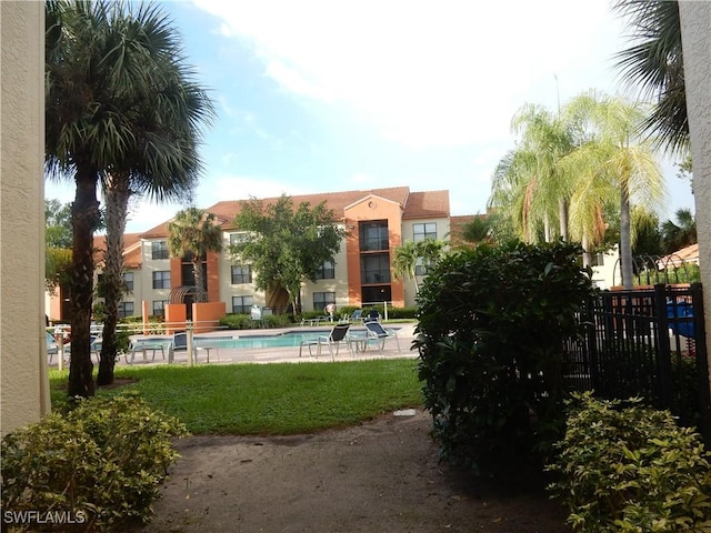 13621 Eagle Ridge Dr Unit 1518, Fort Myers, FL 33912 - rear view of house featuring stucco siding, fence, and a community pool