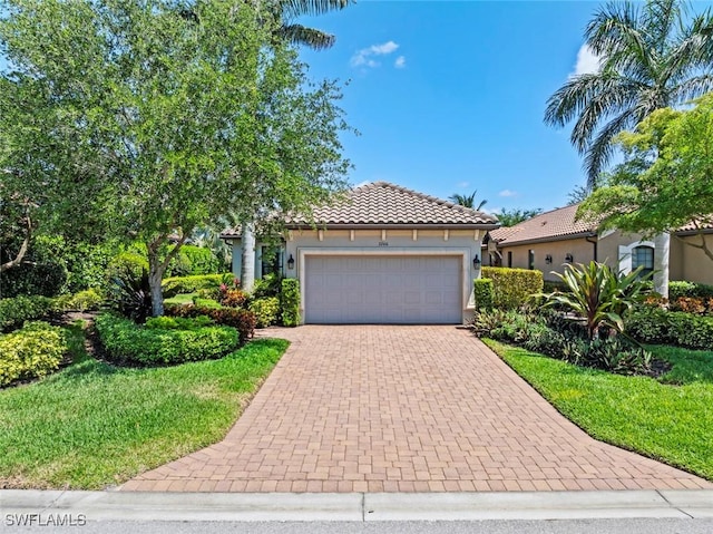 3260 Miyagi Ln, Naples, FL 34114 - view of front of house featuring decorative driveway, an attached garage, a front yard, a tile roof, and stucco siding
