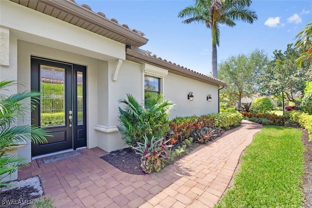 3260 Miyagi Ln, Naples, FL 34114 - view of exterior entry featuring stucco siding