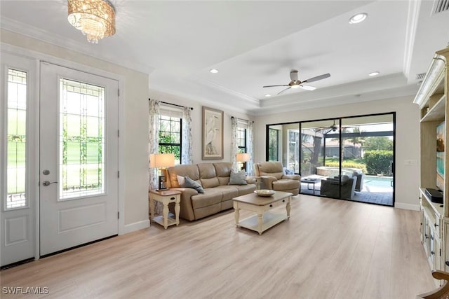 3260 Miyagi Ln, Naples, FL 34114 - living room with a tray ceiling, recessed lighting, light wood-style floors, and crown molding