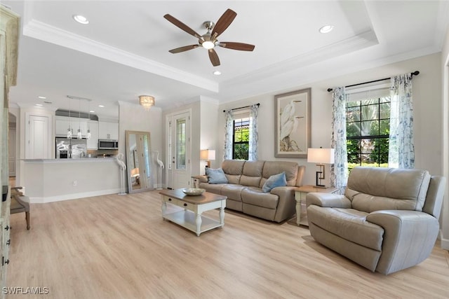 3260 Miyagi Ln, Naples, FL 34114 - living area with a tray ceiling, crown molding, ceiling fan, and light wood-type flooring