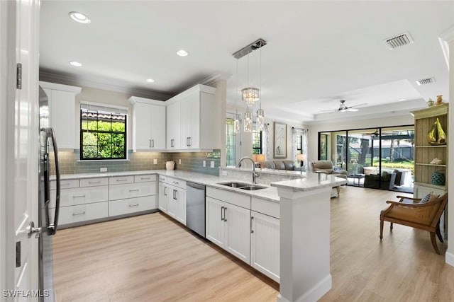 3260 Miyagi Ln, Naples, FL 34114 - kitchen with visible vents, a sink, a peninsula, and dishwasher