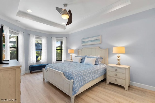 3260 Miyagi Ln, Naples, FL 34114 - bedroom with a raised ceiling, light wood-style floors, and multiple windows